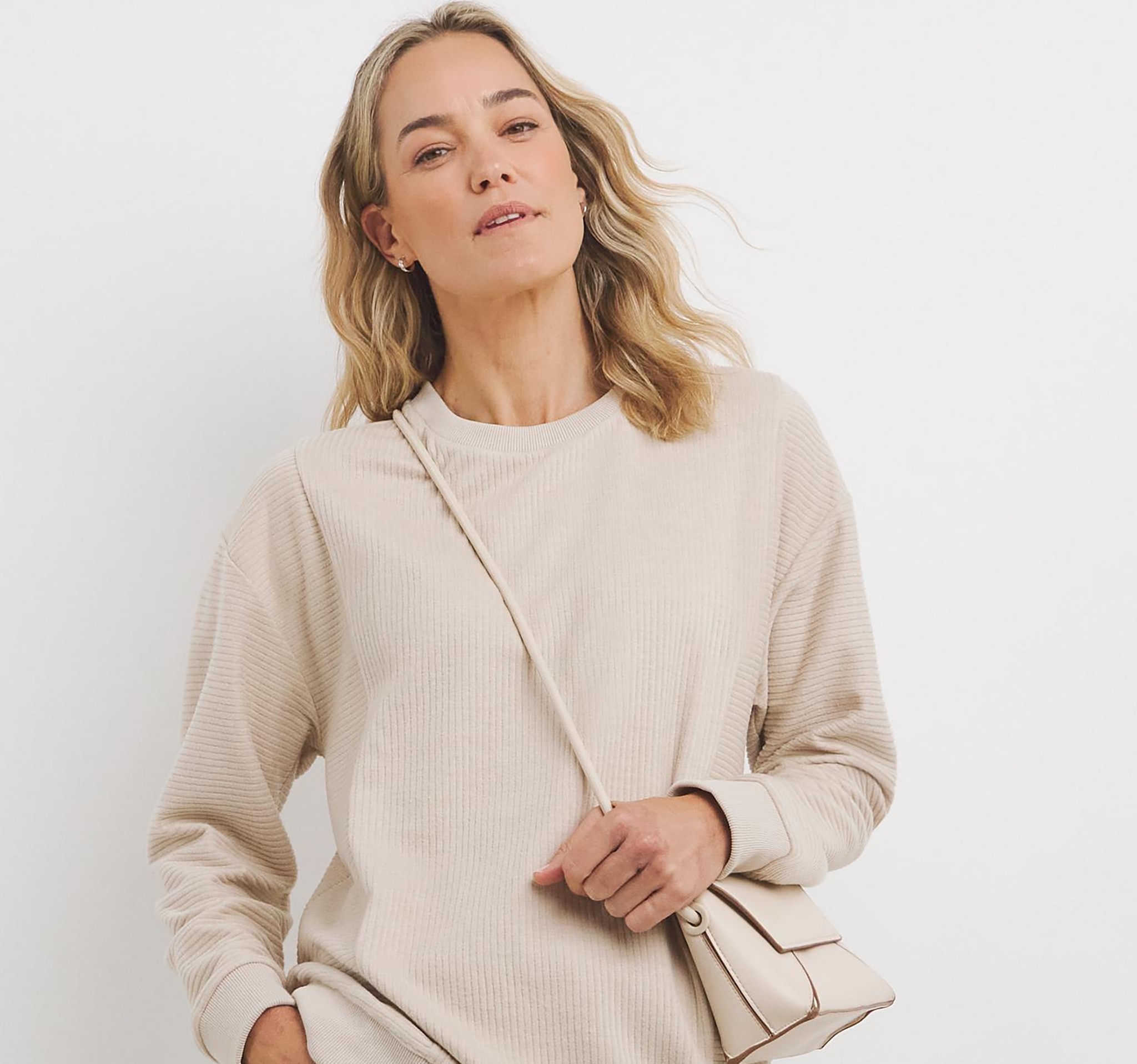 Lady wearing cream crew neck jumper