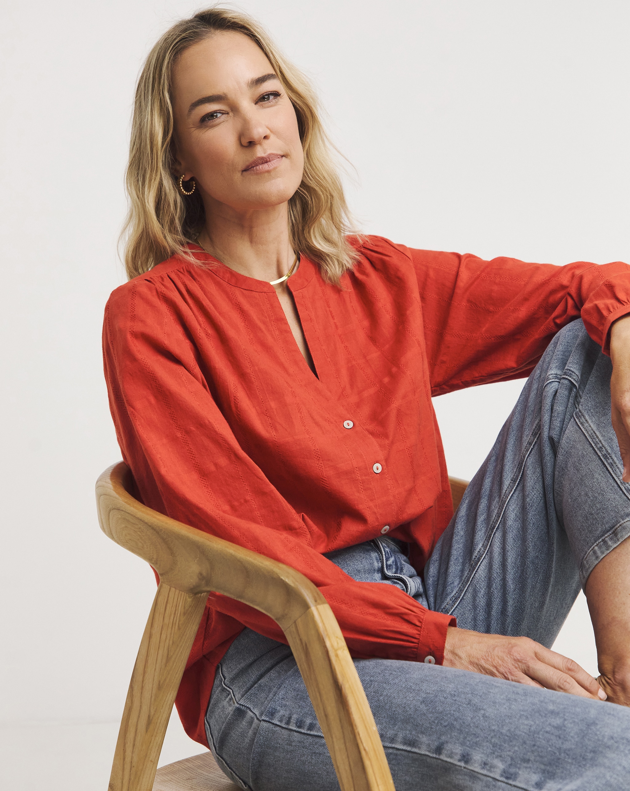 Lady sat in chair wearing red top