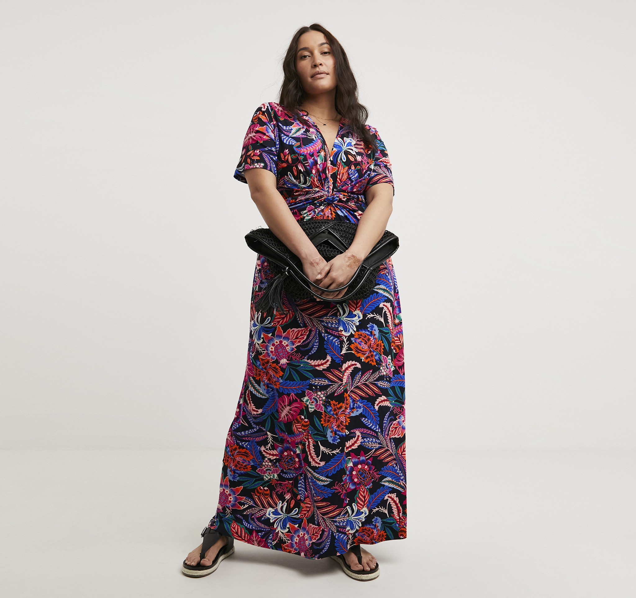 A woman stood wearing a multi coloured maxi dress